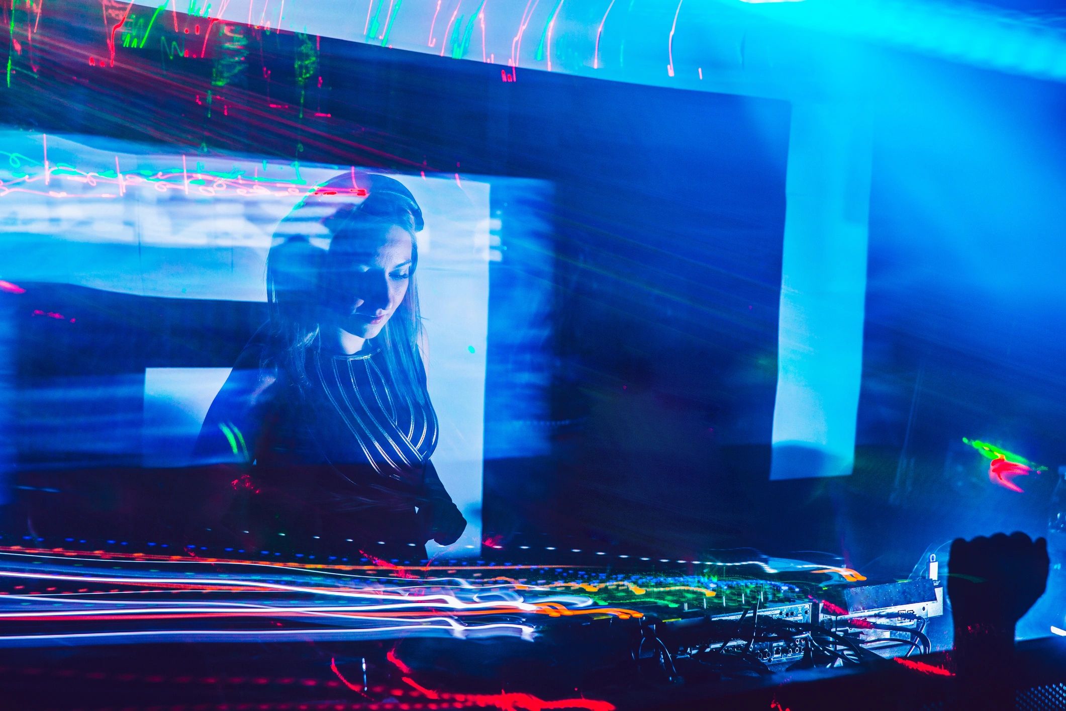 dj performing electronic music event neon lights